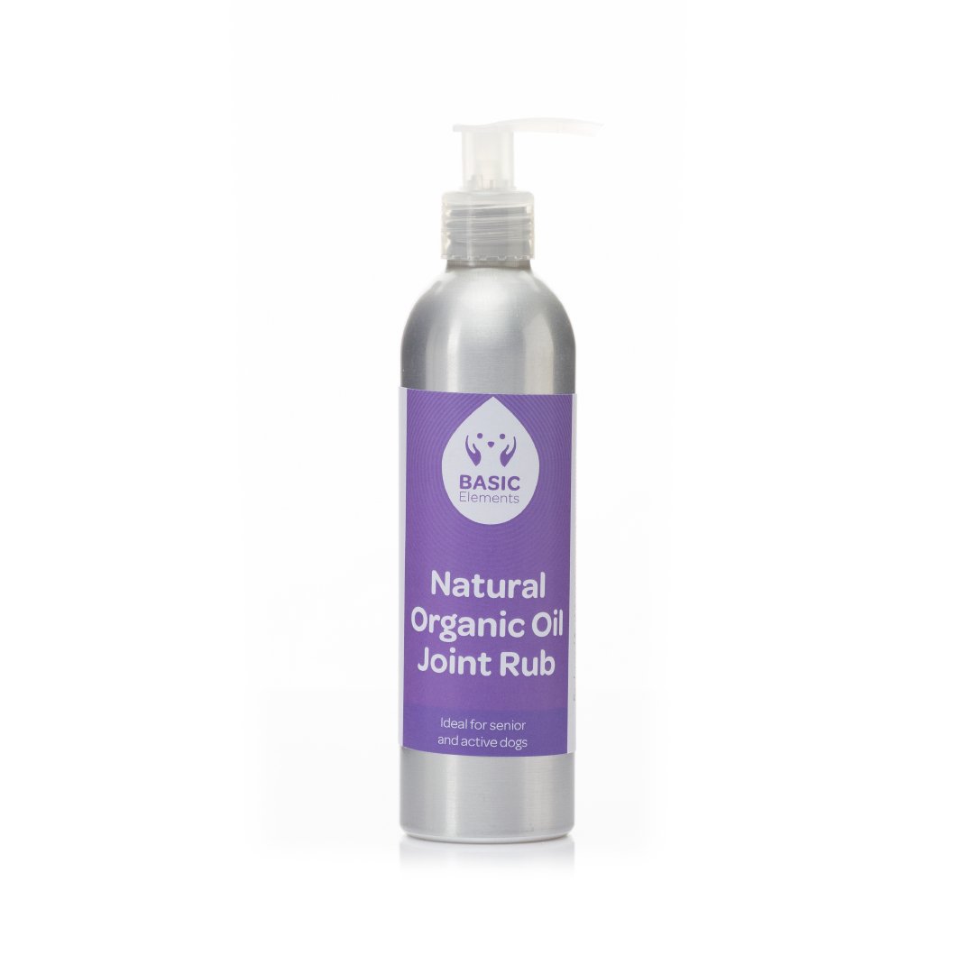 Basic Elements Natural Organic Oil Joint Rub in a silver aluminum pump bottle with a purple label reading “Ideal for senior and active dogs.”